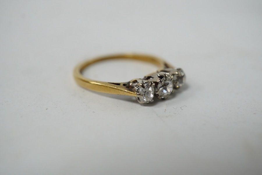 An 18ct gold and three stone diamond set ring, size K, gross weight 2.4 grams. Condition - fair to good